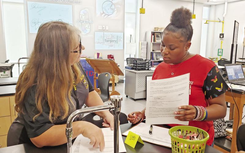 Mount Pleasant High School Forensic Science teacher, Sadonna Parker, goes over class expectations with a new student.