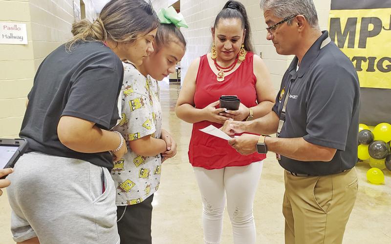 Mount Pleasant Junior High Assistant Principal, Norberto Otero, helps a student find her classroom.