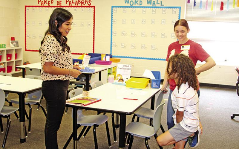 Corprew teacher, Bianca Contreras, welcomes a new student and parent.