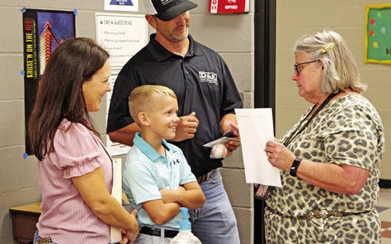 Wallace Middle School art teacher, Terry McCain, welcomes a new family COURTESY PHOTOS