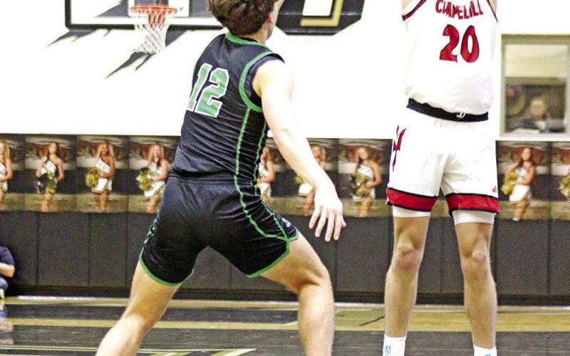 Chapel Hill’s Max Daniel (20) puts up a three-pointer in the first period against Paradise on Friday night in Kaufman.