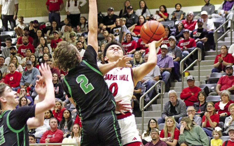 Chapel Hill’s A.J. Ramirez (0) is fouled on this shot attempt in Kaufman on Friday night against Paradise. Ramirez led the Red Devils with 16 points.
