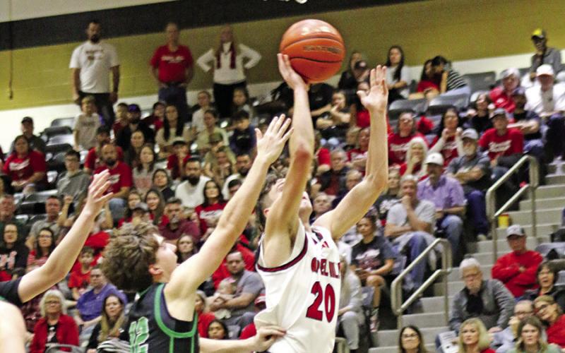 Red Devil senior Max Daniel (20) puts up a shot against Paradise on Friday night in Kaufman. TRIBUNE PHOTOS / MICHAEL S. MCCRACKEN