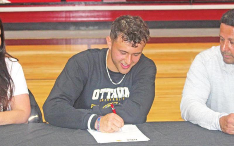 Chapel Hill guard Vincent Rodriguez signed his letter of intent to play basketball at Ottawa University (Kan.) Tuesday morning. He is pictured with his mother, Gina, and his father, Aristeo. TRIBUNE PHOTO / QUINTEN BOYD