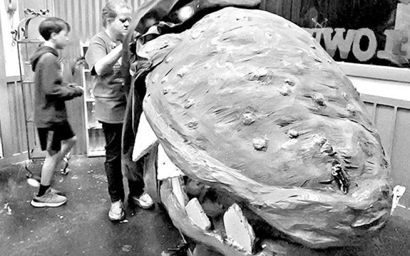 Audrey, the giant space plant, needs five puppeteers to operate it in this musical