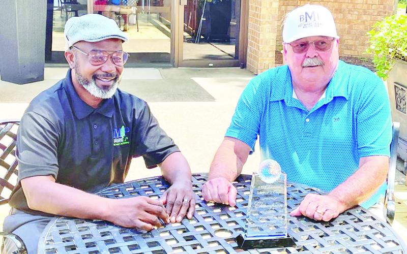 Mount Pleasant mayor, Tracy Craig sits with this year’s champion, Buddy Marshall.