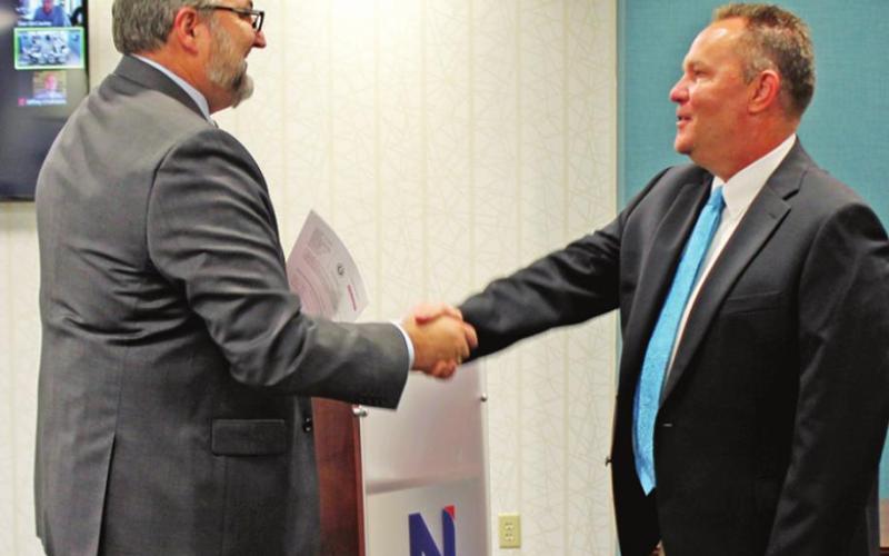 Chad Elledge (right) ran unopposed for Place One and was sworn in by County Judge AJ Mason (left).