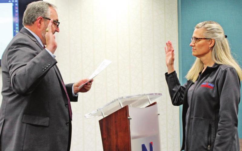 Stephanie Thurman (right) was re-elected for Place Five on the board, and sworn in by County Judge AJ Mason (left).