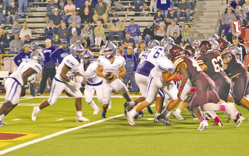 Pewitt’s Hayden Green looks to hand off during Friday’s game at New Boston. The Brahmas fell to the Lions, 50-48. BEE PHOTOS / HEATHER RUSSELL