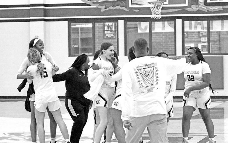 The Mount Pleasant Lady Tigers celebrate following their area round win over Crandall in Lindale. The undefeated, sixthranked Lady Tigers took on Huntsville Tuesday in Athens for a trip to the regional tournament. TRIBUNE PHOTO / QUINTEN BOYD