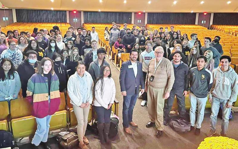 Hefner stands with MPHS students. COURTESY PHOTO