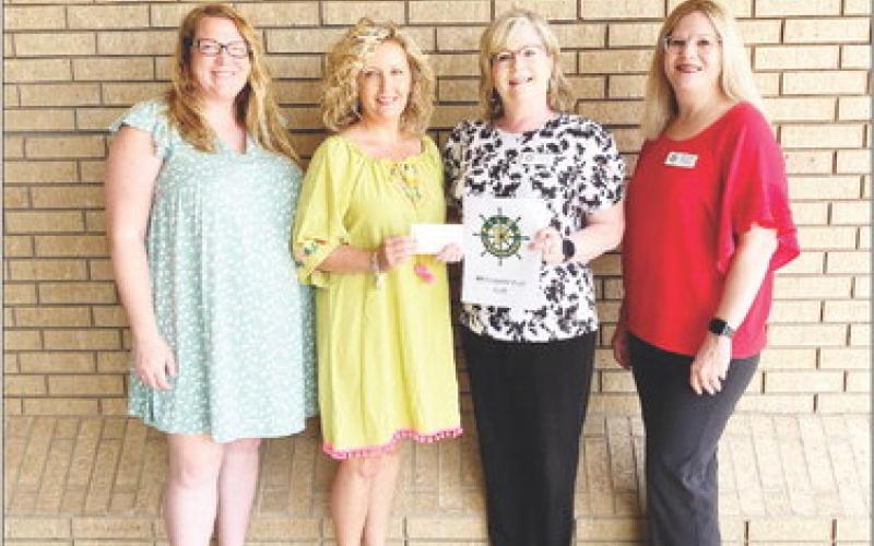 Pilot Club members Shelby Niblett, Denise Davis and Lydia Grimes make a donation to M.O.M, Ministering our Military. Accepting the donation is M.O.M organizer Kelly Cooper. M.O.M. is a nonprofit organization that provides care packages for active-duty military members. COURTESY PHOTO