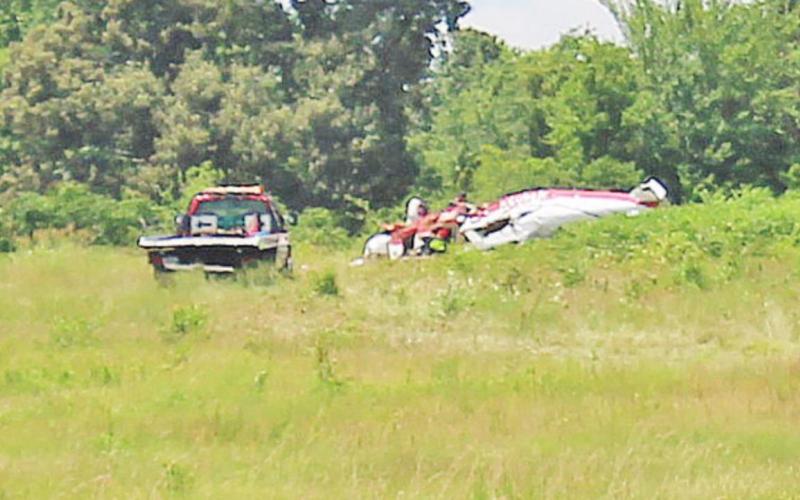 The wreckage of the single engine Piper rests near the tree line where it is expected the plane clipped a tree as it was coming in for a landing at Mount Pleasant Regional Airport Sunday night. TRIBUNE PHOTO / ELIZABETH LANNING