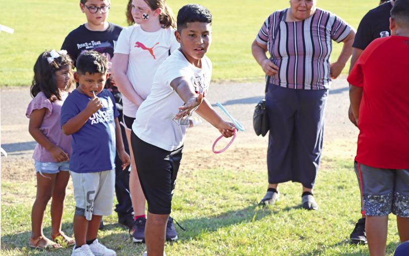 Samuel Castro plays ring toss to win a 2-liter drink COURTESY PHOTO