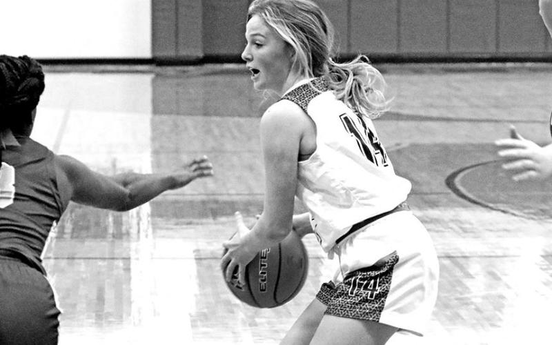 Rivercrest’s Abby Ross collects a loose ball during Tuesday’s game. The Lady Rebels remained unbeaten in district play with a 63-32 win over Detroit.