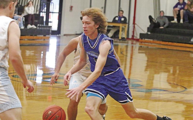 Chase Duffer kicks off a drive to the basket. Rivercrest hosted Detroit Tuesday and will host Maud Friday evening. TRIBUNE PHOTOS / QUINTEN BOYD