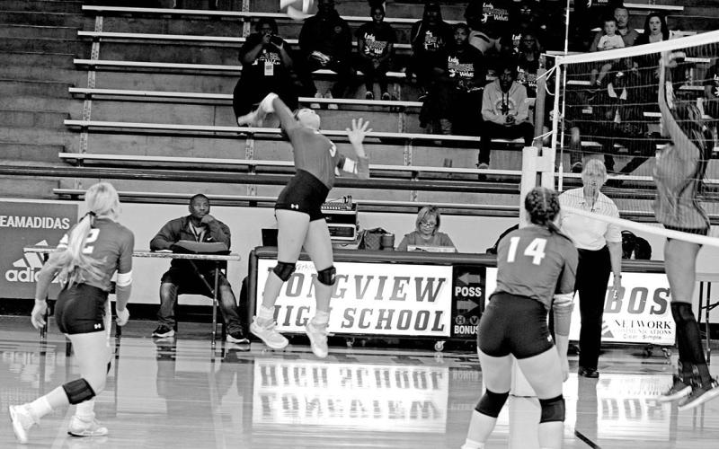 Rivercrest’s Diana Kelley jumps for a spike during Friday’s area round matchup against San Augustine as teammates Vivian Hines (left) and Kynzie Franks (right) look on. The Lady Rebels lost a tight matchup to the Lady Wolves, 3-1 (19-25, 25-22, 24-26, 26-28). TRIBUNE PHOTO / QUINTEN BOYD