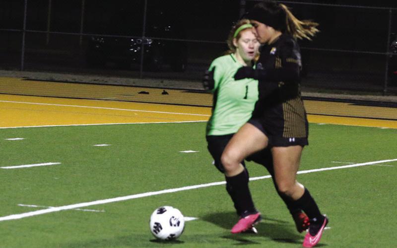 Karina Torres makes her way past Texas High goalkeeper Kaylee Norton on her way to scoring her second goal in Mount Pleasant’s 4-0 win. PHOTO BY QUINTEN BOYD
