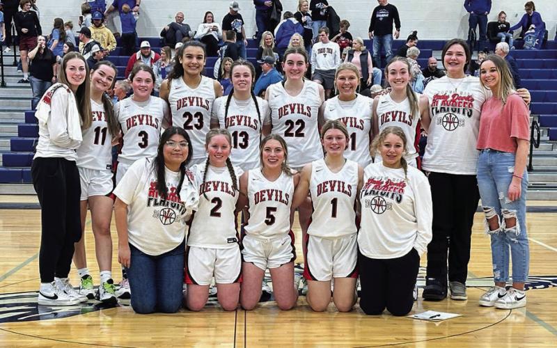The 2022 Chapel Hill Lady Devils pose victorious after a 59-27 win over the Hooks Lady Hornets Monday night that earned them a Bi-District Championship and pushed them on to the next round of the basketball playoffs. COURTESY PHOTO