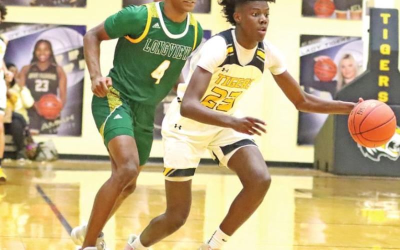 Freshman Reggie Webster drives to the basket vs Longview. PHOTO BY JOHN WHITTEN
