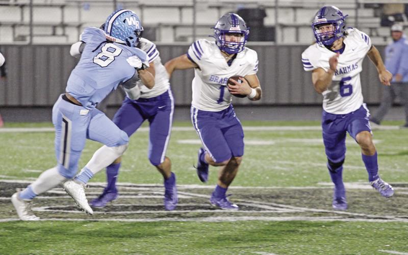 Pewitt’s Hayden Green looks for room around the outside during Friday’s bi-district game against West Rusk as JD Smith escorts him.