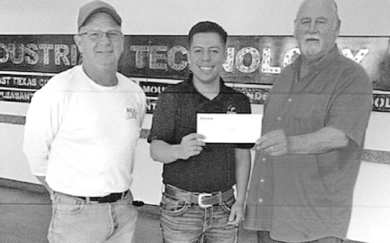 Secretary and treasurer Tim Davis, recipient Christian Flores and president Erman Hensel. COURTESY PHOTO