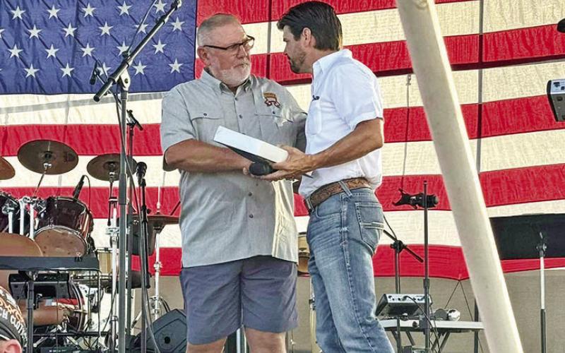 A veteran receives a special award from Cole Heffner