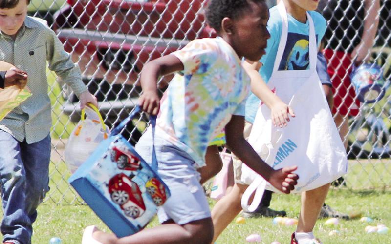 This eager little boy immediately sprinted off to collect the Easter eggs. TRIBUNE PHOTOS / RYLEIGH STEGALL