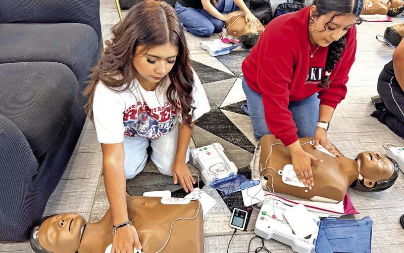 Diana Gutierrez (left) and Angie Castro apply AED pads to their mannequins Courtesy Photos