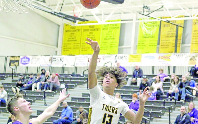 Mount Pleasant’s Kyler Smith puts up a shot during Tuesday’s home game against Hallsville. The Tigers won, 58-37.