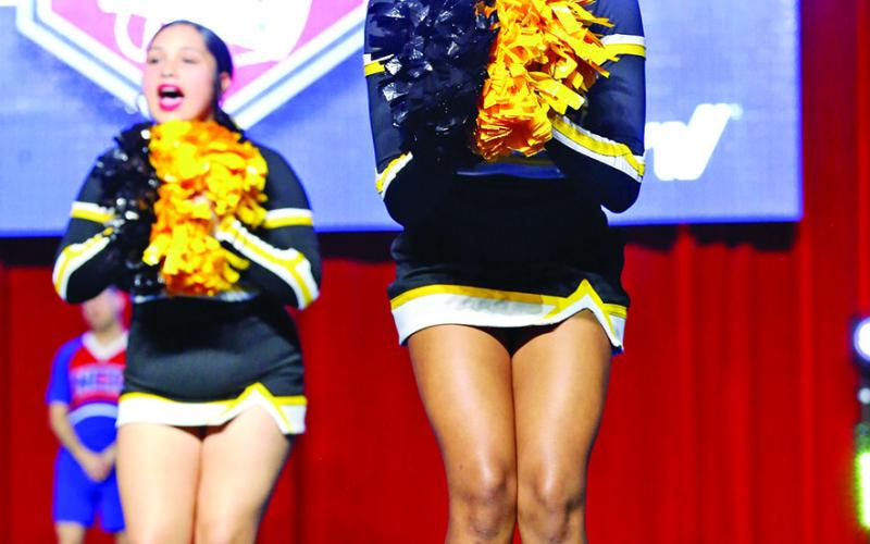 Shannon Hines (front) and Ana’liece Guerrero cheer for the Tigers
