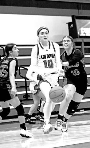 Chapel Hill’s Keira Hawkins (10) splits two defenders on her way to the basket during a recent home game. TRIBUNE PHOTOS / MICHAEL S. MCCRACKEN