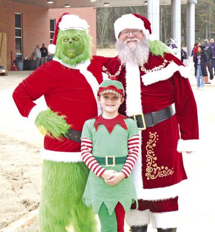 The Grinch, Santa Claus, and elf spread joy