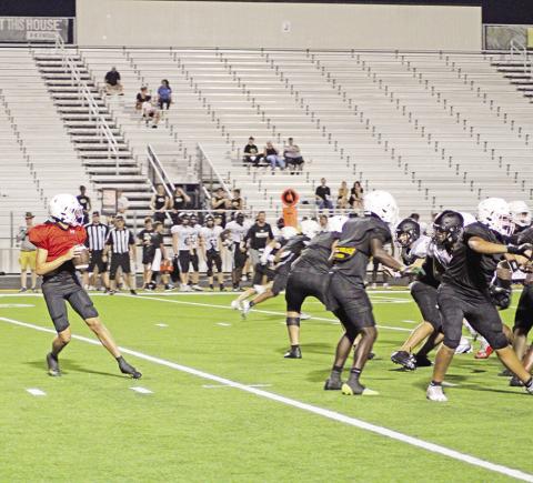 Mount Pleasant’s Mason McMinn drops back to pass during last week’s scrimmage against Pleasant Grove. The Tigers open their season Friday at Sam Parker Field against Pittsburg.