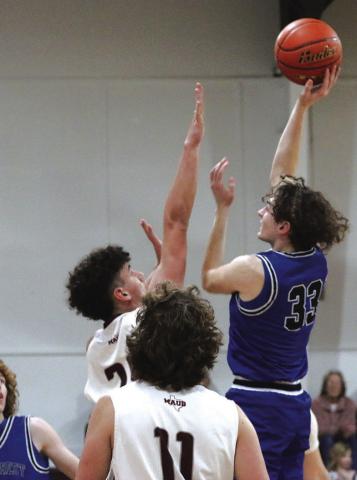 Rivercrest’s Noah Altal puts up a shot over Maud’s Lane Sultz during Tuesday’s game. The Rebels fell against the Cardinals, 59-48. Rivercrest opens the playoffs at 6 p.m. Tuesday against North Hopkins at Mount Vernon High School. PHOTO BY QUINTEN BOYD