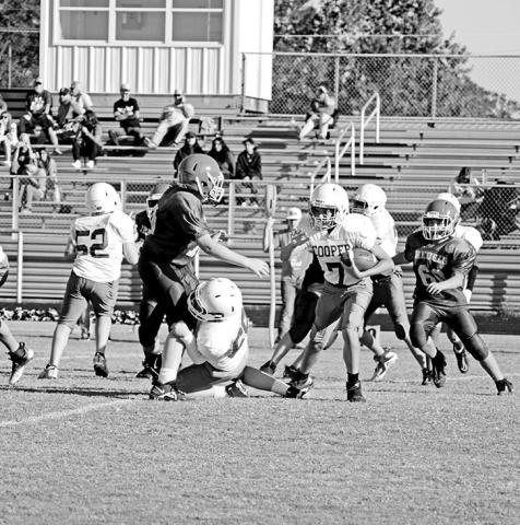 Rivercrest seventh grade football players Beck Perkins (left) and Cash Carroll chase down a Cooper running back during Thursday’s game. The seventh grade Rebels fell to the Bulldogs, 14-0.