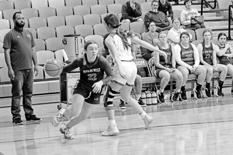 Rivercrest’s Anna Duvall drives toward the basket as Head Coach Joshua Medlock looks on during Tuesday’s game at Chisum. TRIBUNE PHOTO / QUINTEN BOYD