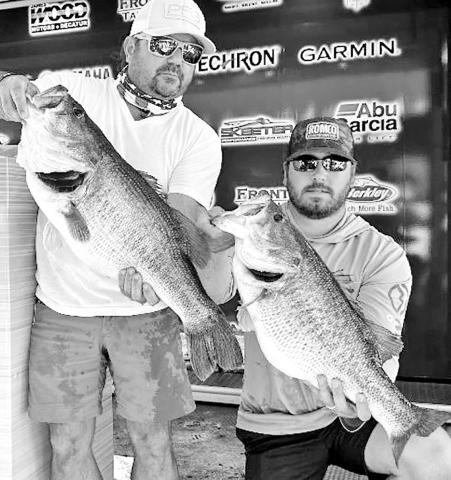 Lee Beuershausen of Marble Falls (left) and Carson Bowen of Burnet were on some big ones during the Bass Champs team event held at Lake O.H. Ivie. The two anglers weighed in a hefty 36.59-pound sack that was anchored by these two giants, a 13.54 pound Legacy Lunker and a 11.5 pounder. BASS CHAMPS PHOTO