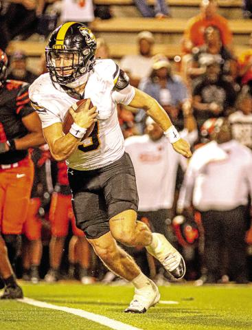 Mt. Pleasant Quarterback Carter Cook looks for an opening and picks up a first down against Texas High.(Cook-15/24 for 167 yards + 72 rushing yards-1 TD-1 INT)