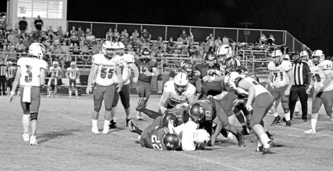 From left, Rivercrest’s Dalton Lovett (#22), Ethan Taylor (#53) and JaQuan Brown (#33) wrestle down a ball carrier during a recent game. The Rebels will celebrate Homecoming Friday during their district opener against Como-Pickton. TRIBUNE PHOTO / QUINTEN BOYD