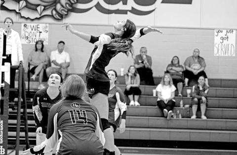 Harts Bluff’s Alexis Gonzalez jumps for a spike as teammates Ally Cook (foreground), Kaitley Green (background, left) and Allie Mayfield (background, right) look on. The Lady Bulldogs split their two games last week. TRIBUNE PHOTO / QUINTEN BOYD