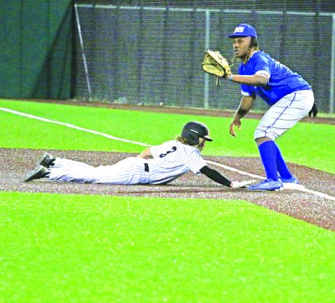 Mount Pleasant’s Christian Johnson slides back to first base as Tyler’s Tory Howland awaits the throw. The Tigers won over the Lions, 7-1. TRIBUNE PHOTO / QUINTEN BOYD