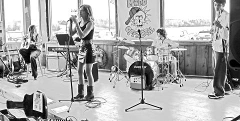 Cover band MADD Official, a group of kids from Chapel Hill ISD, performs an array of rock songs at Big Al’s Barefoot Bay on Feb. 15. (From left to right) guitarist Claire Kastan, lead singer Ayva Morin, (behind Morin) special guest pianist David Sekulic, drummer Drew Mays and bassist Atticus Day-Alleman. Photo by Lexi DeLaRosa