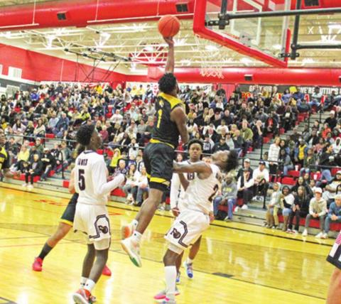Mount Pleasant’s Will Hills drives for a layup during Saturday’s area round game. TRIBUNE PHOTO / QUINTEN BOYD