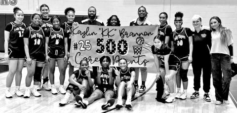 Kaylin Brannon with the Lady Tigers and coaches as they celebrate a huge milestone.
