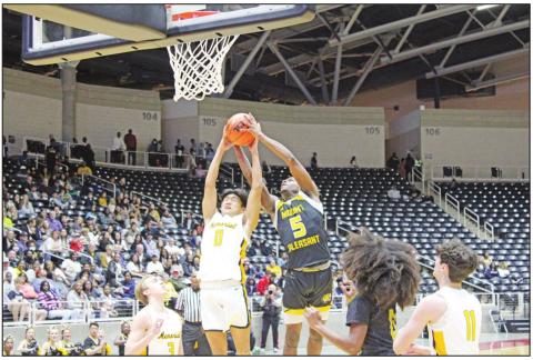 Mount Pleasant’s Ed Wilder rips a rebound away from Memorial’s Mason Kim during Friday’s regional semifinal. The Tigers fell to the Warriors, 72-54. TRIBUNE PHOTO / QUINTEN BOYD