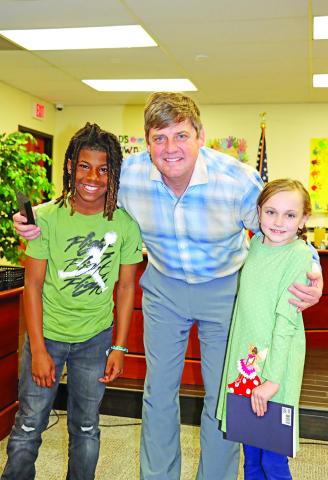 Brice NEHS President Jamari Meeks (left) and Vice President Anna Henry (right) honor Dr. Kenny Thompson