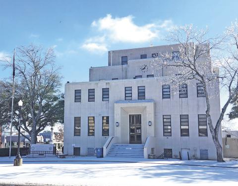 Titus County Courthouse surrounded by a layer of snow
