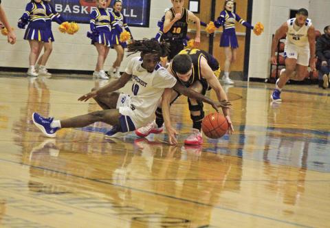 Harts Bluff’s Avyn Carrington (right) battles with Rivercrest’s Cameron Lowe (left) for a loose ball during Wednesday’s district game. The Rebels held on for a 39-36 win over the Bulldogs.
