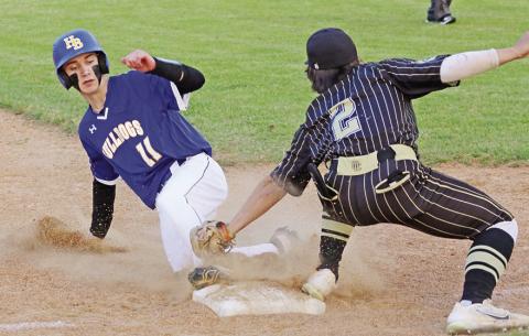 Harts Bluff’s Cohen Williams slides underneath a tag attempt by Ore City’s Jordan Escamilla during Tuesday’s game. The Bulldogs fell in their season finale against the Rebels, but won three games in their first full UIL season -- picking up the program’s first-ever victory with a win over Sulphur Bluff and sweeping Detroit in district play. TRIBUNE PHOTO / QUINTEN BOYD